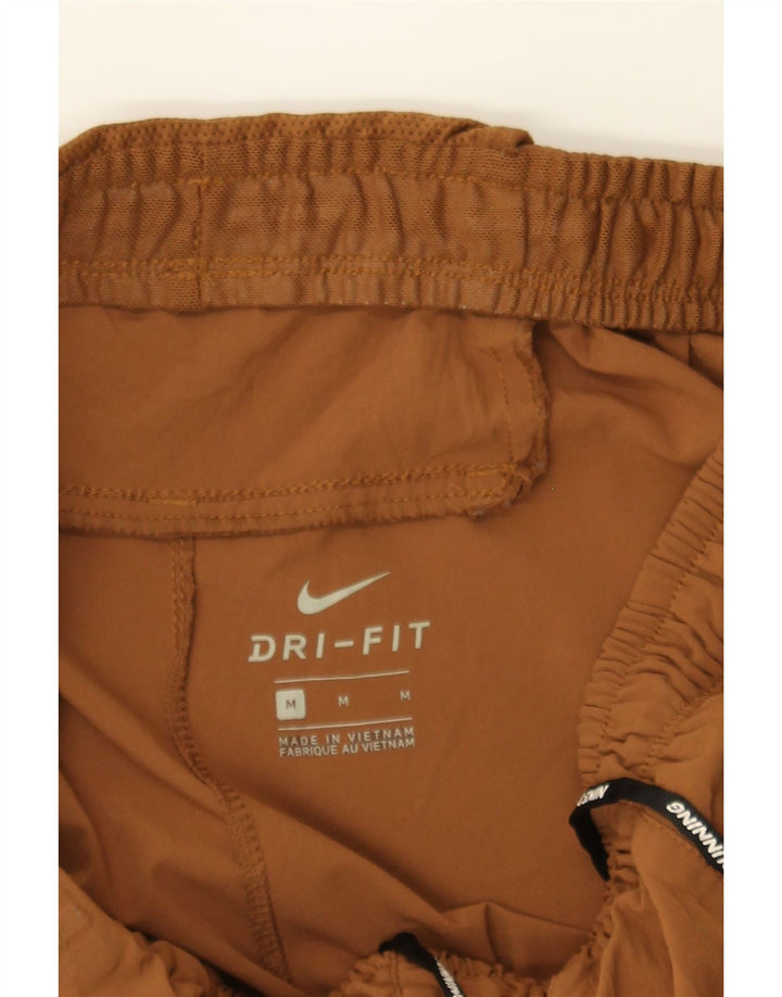 NIKE Girls Dri Fit Tracksuit Trousers 10-11 Years Medium Brown Polyester Vintage Nike and Second-Hand Nike from Messina Hembry 