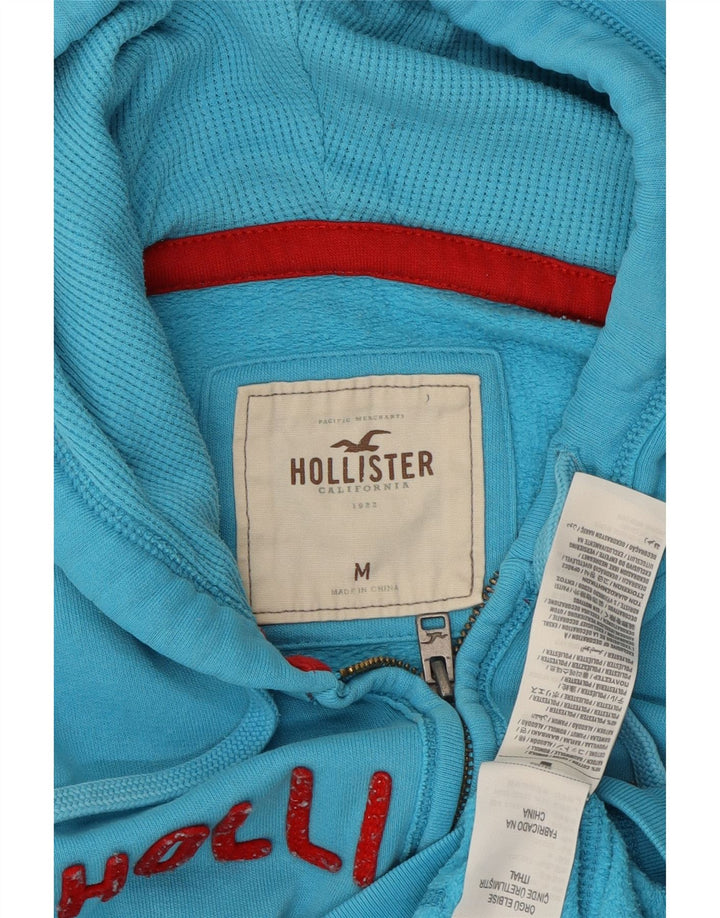 HOLLISTER Ženski pulover s kapuljačom s grafičkim patentnim zatvaračem UK 14 Srednje plavi pamuk