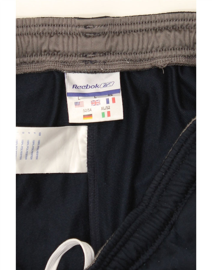 REEBOK Mens Tracksuit Trousers Large  Navy Blue Colourblock Polyester Vintage Reebok and Second-Hand Reebok from Messina Hembry 