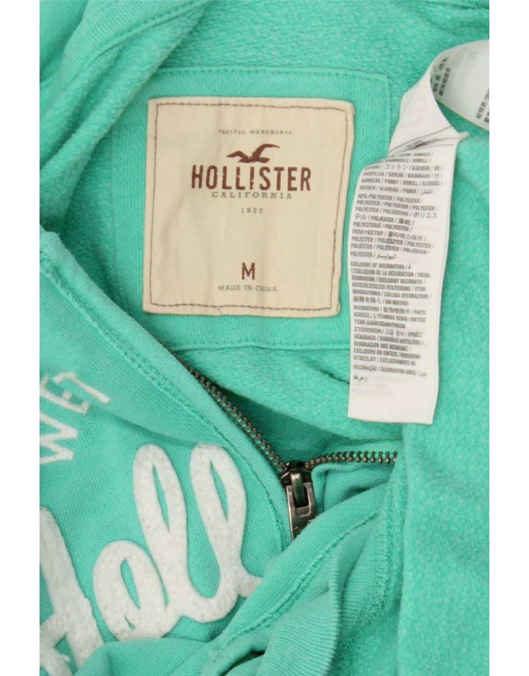 HOLLISTER Ženski pulover s kapuljačom s grafičkim patentnim zatvaračem UK 14 srednje tirkizni pamuk