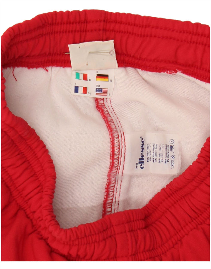 Ellesse ženske hlače vjetrovke sa stremenom US 6 srednje crvene najlonske boje
