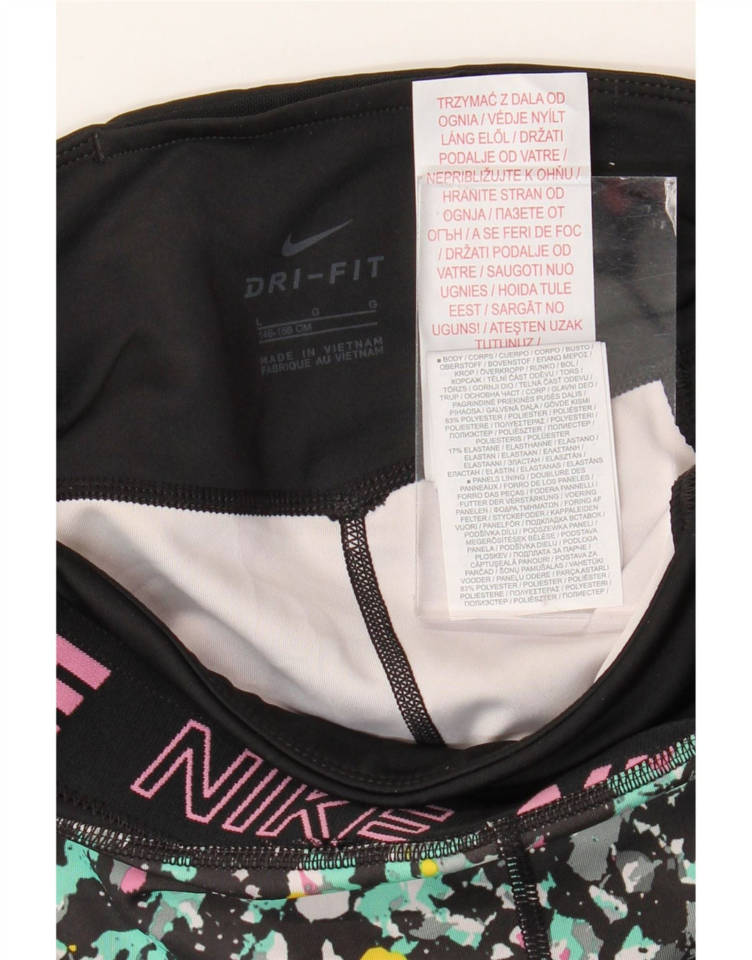 NIKE Girls Dri Fit Graphic Leggings 12-13 Years Large Black Spotted