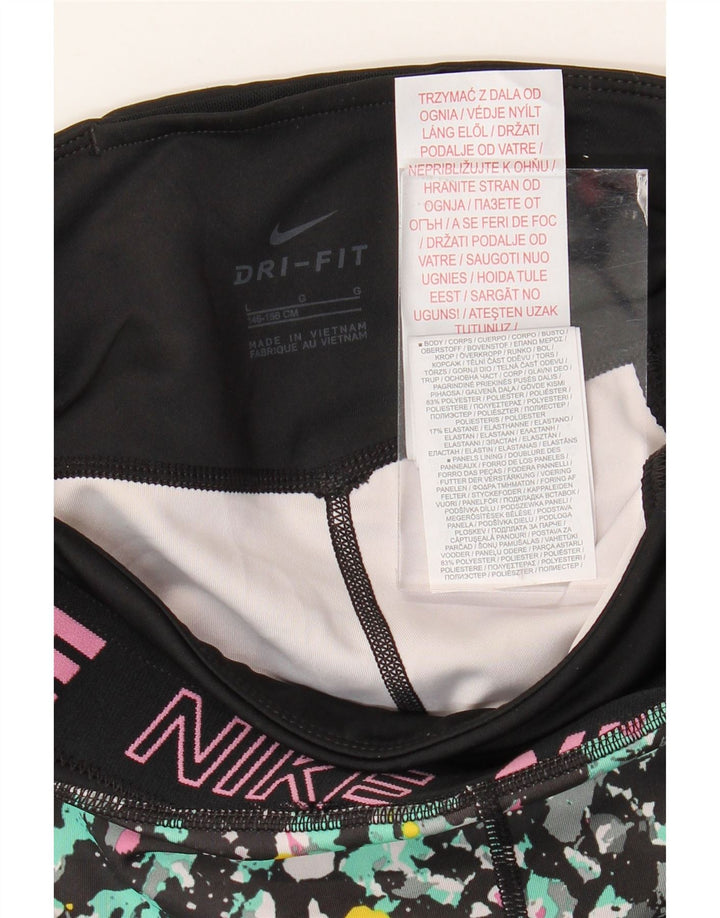 NIKE Girls Dri Fit Graphic Leggings 12-13 Years Large Black Spotted